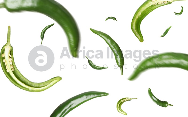 Image of Green chili peppers falling on white background 