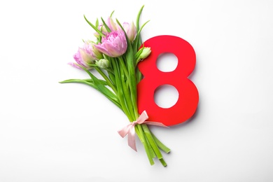 8 March greeting card design with tulips on white background, top view