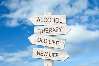 Alcohol addiction: what to choose - therapy or life with bad habit? Wooden signpost with different directions against blue sky