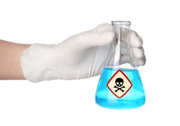 Scientist in gloves holding glass bottle with blue toxic sample and warning sign on white background
