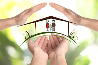 People forming house with their hands and illustration of family on blurred green background, closeup