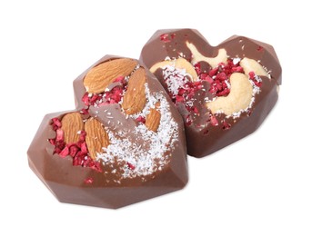 Photo of Tasty chocolate heart shaped candies with nuts on white background