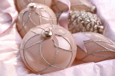 Set of beautiful Christmas baubles and ribbon in box, closeup