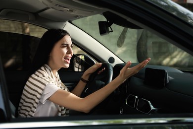 Stressed young woman driver's seat of modern car