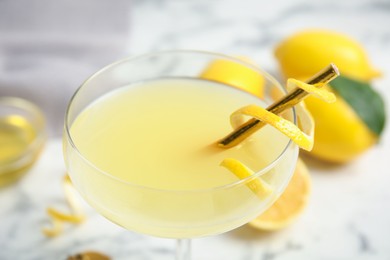 Delicious bee's knees cocktail on white table, closeup
