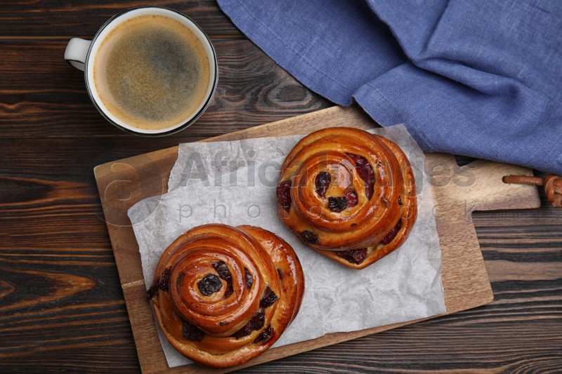 Photo of Delicious pastries and coffee on wooden table, flat lay