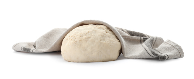 Dough for pastries covered with napkin on white background