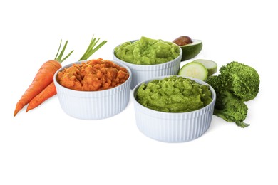 Different delicious puree in bowls and fresh ingredients on white background. Healthy food