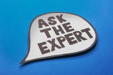 Speech bubble sticker with phrase Ask The Expert on light blue background