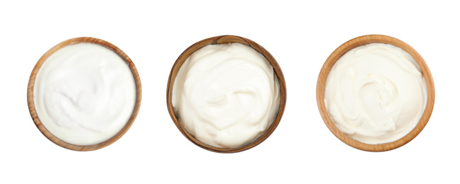 Set of delicious natural yogurt in bowls on white background, top view