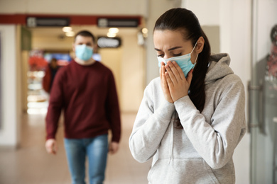 People wearing disposable masks indoors. Dangerous virus