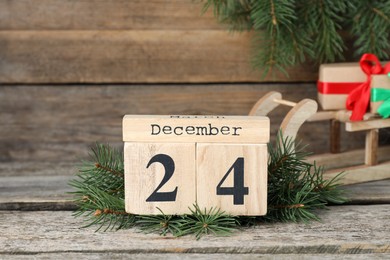 December 24 - Christmas Eve. Wooden block calendar and festive decor on table
