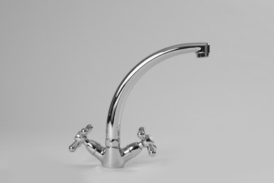 Double handle water tap on grey background