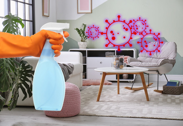 Image of Keep your home virus-free. Woman cleaning room with disinfecting solution