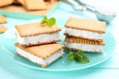 Sweet delicious ice cream cookie sandwiches on light blue wooden table