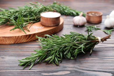 Bunch of fresh rosemary on wooden table