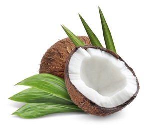 Tasty ripe coconuts and green leaves on white background