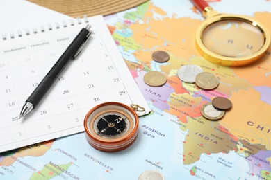 Different travel accessories on world map. Planning summer vacation trip