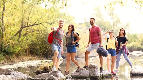Group of friends hiking outdoors. Camping vacation