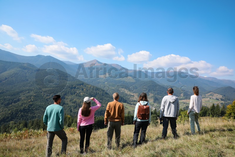 Group of people spending time together in mountains, back view