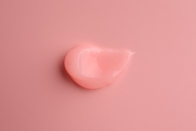 Sample of cosmetic gel on pink background, top view