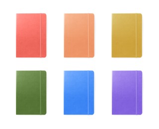 Set with multicolor notebooks on white background, top view