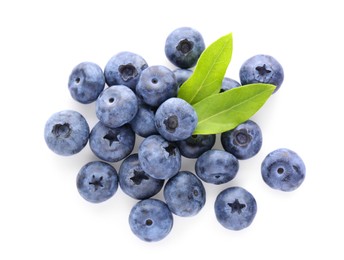 Pile of tasty fresh blueberries and green leaves on white background, top view