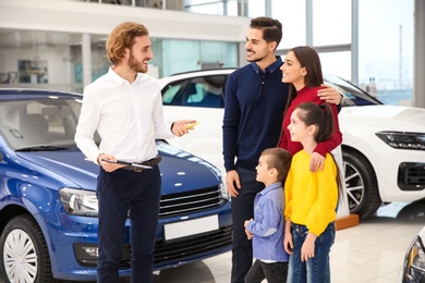 Car salesman working with family in dealership