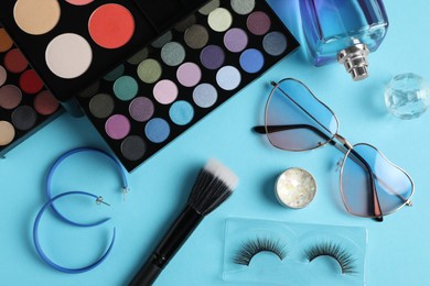 Photo of Set of makeup products and accessories on light blue background, flat lay