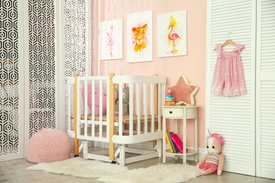 Cute pictures and crib in baby room interior