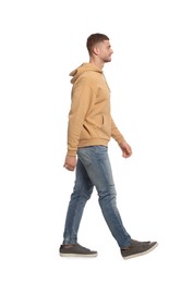 Photo of Man in casual outfit walking on white background