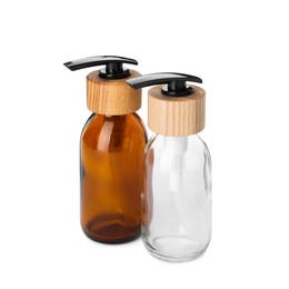 Two empty glass bottles with dispenser caps on white background