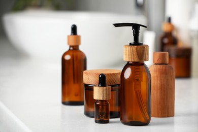 Different personal care products on countertop in bathroom, closeup. Space for text