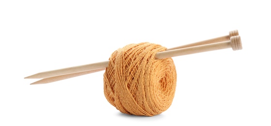Photo of Clew of colorful thread with knitting pins on white background