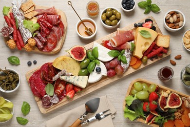Photo of Set of different delicious appetizers served on white wooden table, flat lay