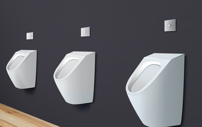 Clean ceramic urinals in men's public bathroom