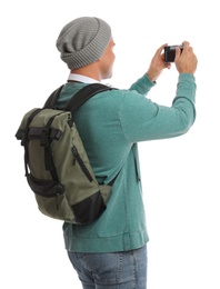 Man with backpack taking picture on white background. Autumn travel