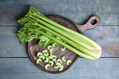 Fresh ripe celery on blue wooden table, top view