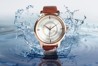 Luxury men's watch in water splashes demonstrating its waterproof