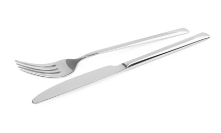 New shiny fork and knife on white background
