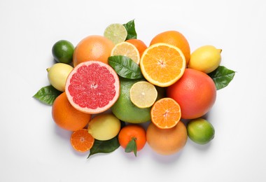 Photo of Different citrus fruits with fresh leaves on white background, top view