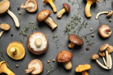 Flat lay composition with fresh mushrooms, thyme and pepper on grey background