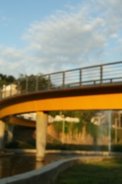 Photo of Blurred view of modern bridge in park