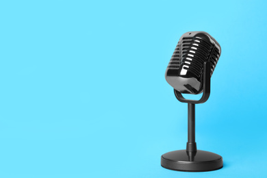 Retro microphone on light blue background, space for text. Interview