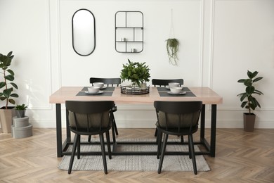 Photo of Stylish wooden dining table and chairs in room. Interior design