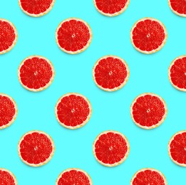 Many fresh ripe slices of grapefruits on turquoise background, flat lay. Seamless pattern design