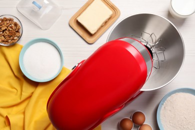 Photo of Modern red stand mixer and different ingredients on white wooden table, flat lay