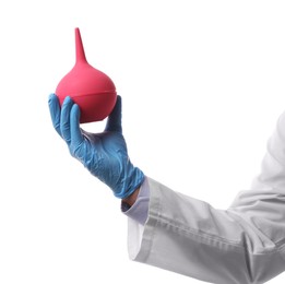 Doctor holding pink enema on white background, closeup