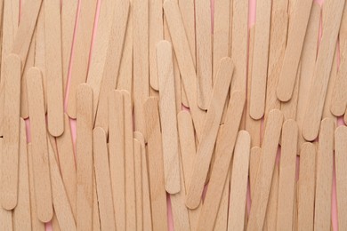 Disposable wooden waxing spatulas as background, closeup view