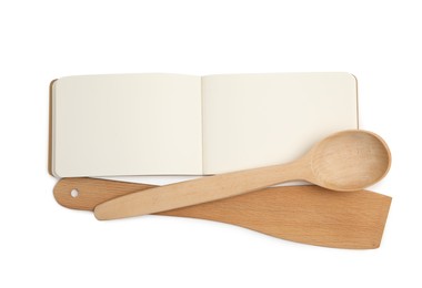Blank recipe book and wooden utensils on white background, top view. Space for text